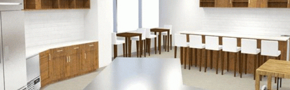 Modern minimalistic dining area with wooden tables and white chairs.