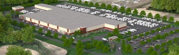 A large parking lot filled with white vehicles surrounding a beige building.