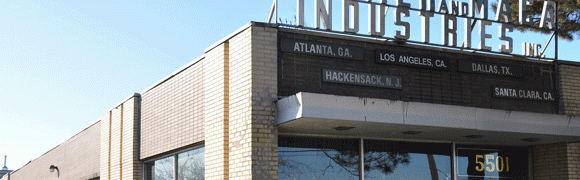 A brick pillar with signs pointing to various cities including Atlanta, GA.