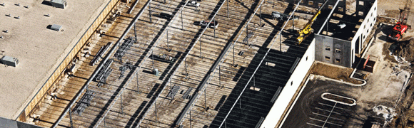 Aerial view of railway tracks with wooden sleepers and gravel.