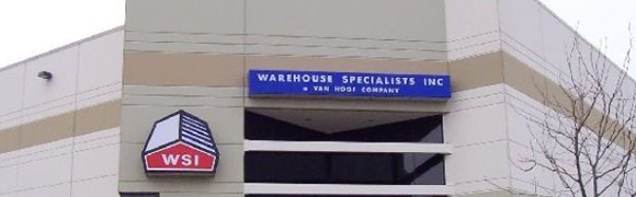 Signboard reading 'Warehouse Specialists & Van Hoof Company' on a building.