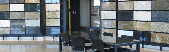 Modern dining area with black chairs and a glass table.