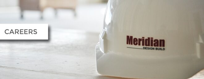 White construction helmet with 'Mer' text on a table.