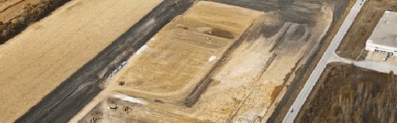 Wooden door embedded in a sandy surface.