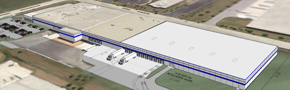 Warehouse building with loading docks and trucks.