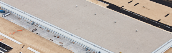 Aerial view of large industrial building.
