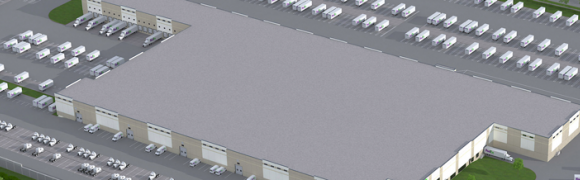 Aerial view of large warehouse and parking.