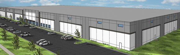 Large industrial warehouse with parking lot.