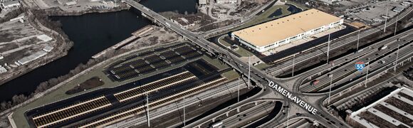 Aerial view of highway and industrial buildings.