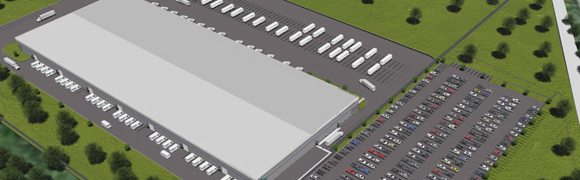 Aerial view of large warehouse and parking.