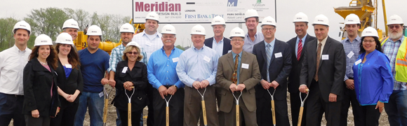 Groundbreaking ceremony with people in hard hats.