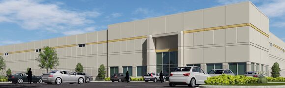 Modern warehouse building with parked cars outside.
