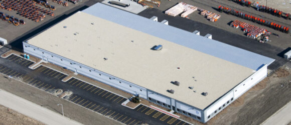 Aerial view of large industrial warehouse building.