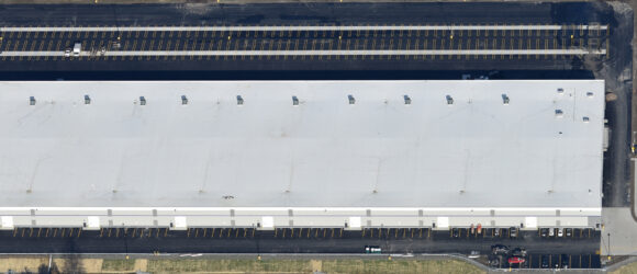 Aerial view of large industrial warehouse building.