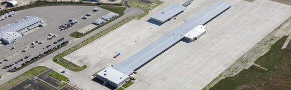 Aerial view of industrial buildings and parking.