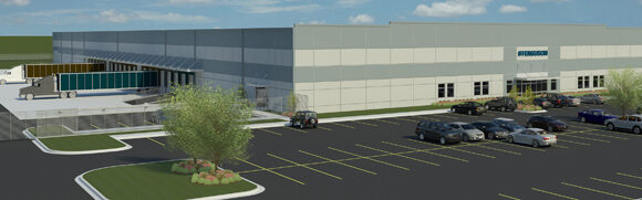 Modern industrial building with parking lot.