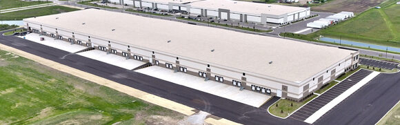 Aerial view of large industrial warehouse building.