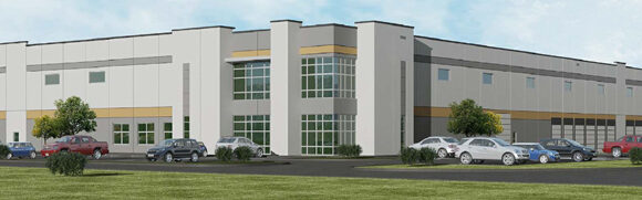 Modern warehouse building with parked cars.