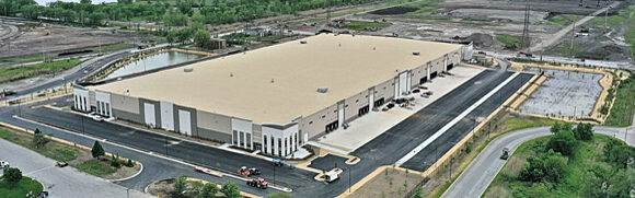 Large industrial warehouse with surrounding roads.