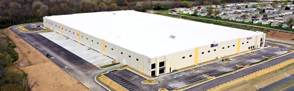 Large warehouse building with surrounding parking lot.