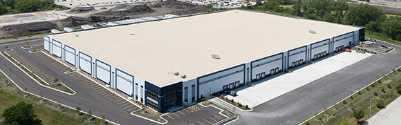 Large industrial warehouse with surrounding parking lot.