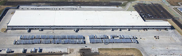 Aerial view of large distribution warehouse facility.