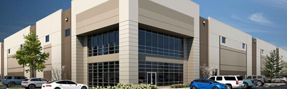 Modern industrial building with parked cars.